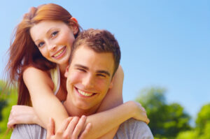 An attractive young woman embracing her handsome boyfriend